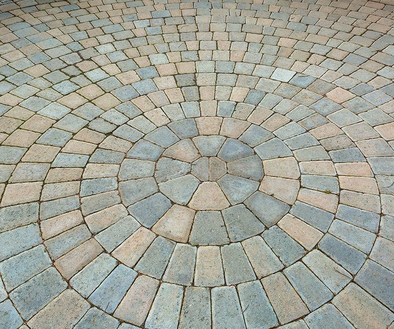 brick patio pavers in circular pattern.