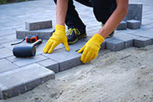 Stone Mason installing driveway pavers in Columbia, SC