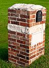 brick mailbox that has been repaired by masonry contractors